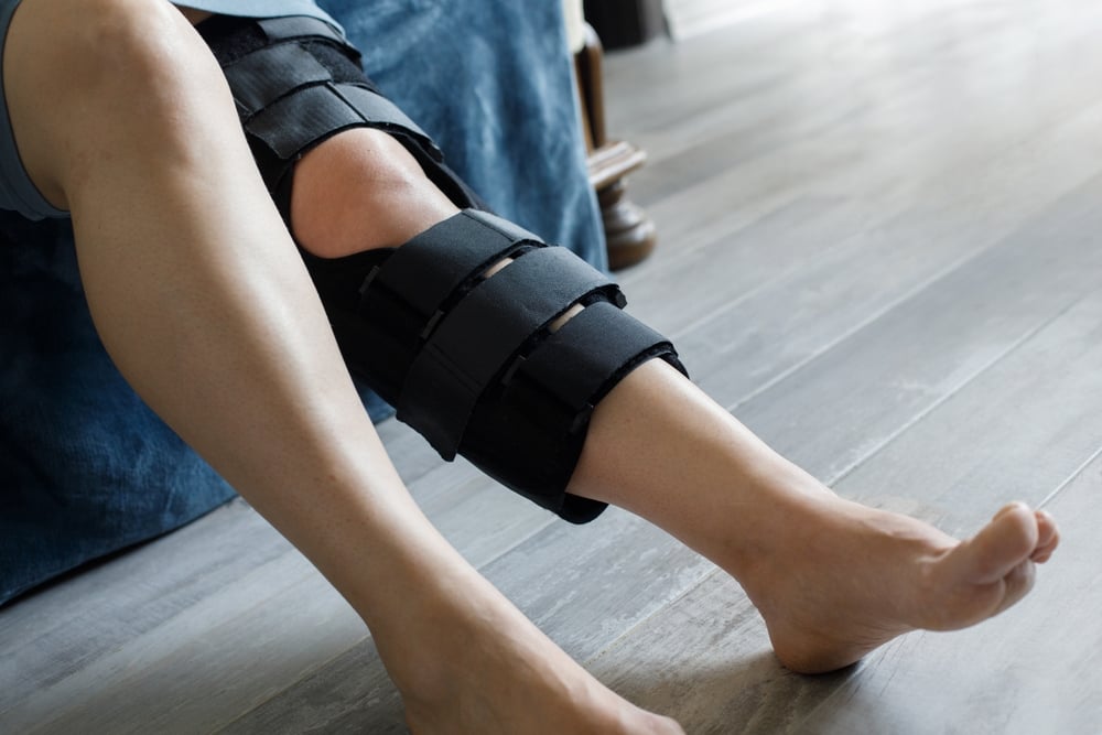 patient,wearing,knee,brace,support,after,injury,and,surgery.,healthcare